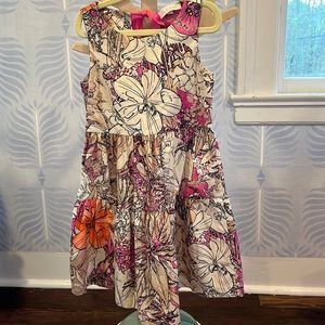 Sleeveless cotton dress with ribbon back closure and hibiscus flower motif.